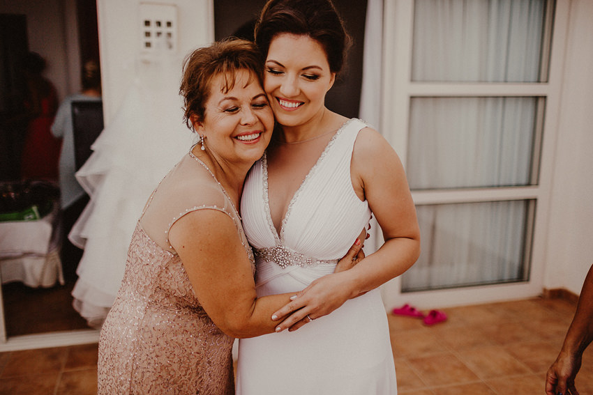 Bride and her mother hugging 