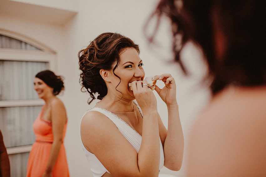 funny moment bride eating sandwich in wedding dress