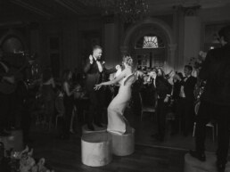 Bride and Groom dancing on the podiums with all the guests around them