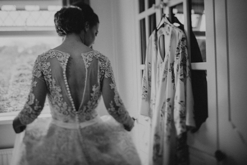 Maureen putting her dress on - black and white documentary picture