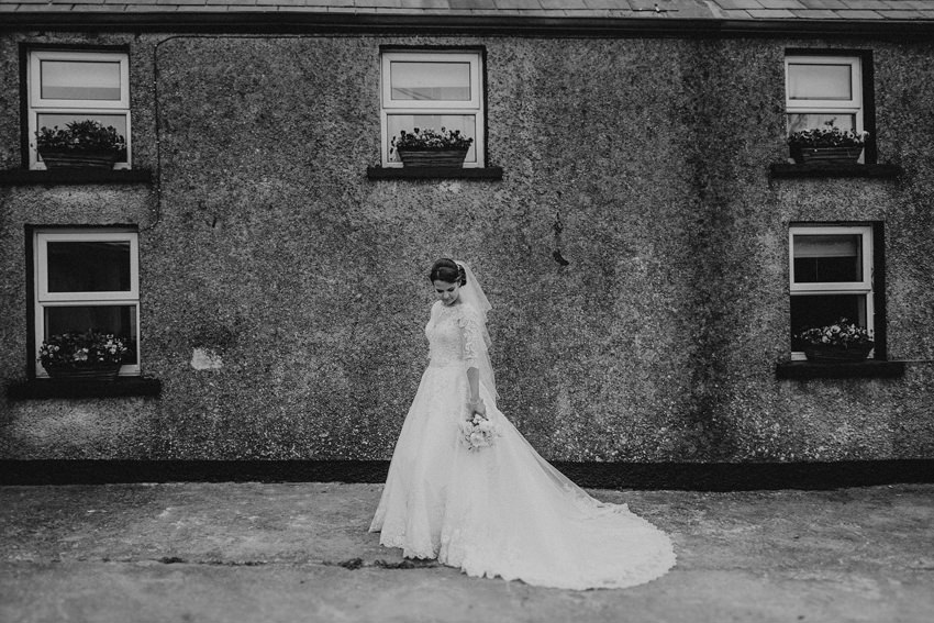 blacj and white rustic portrait of the bride at the old house