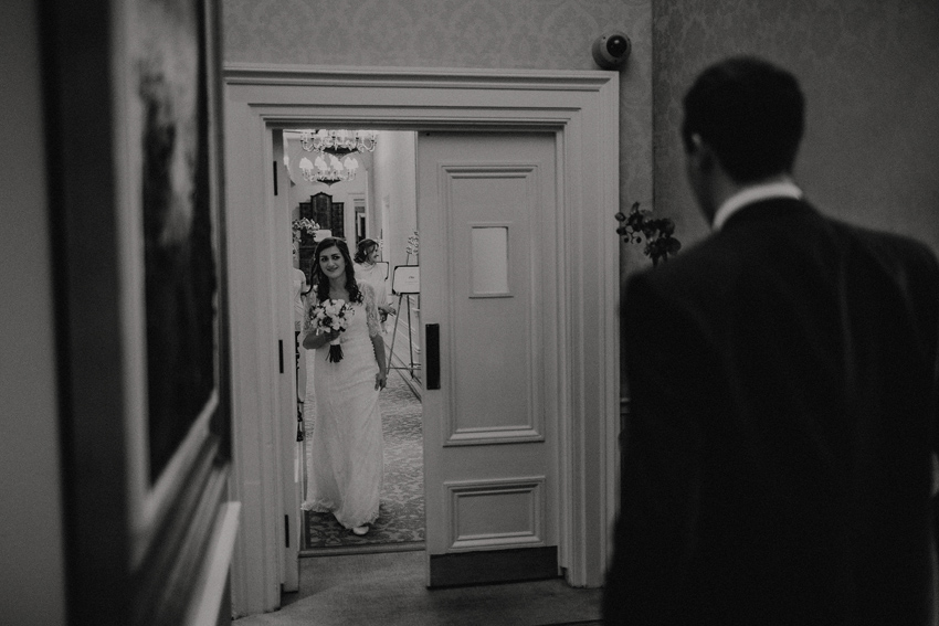 bride and groom are sharing a first look