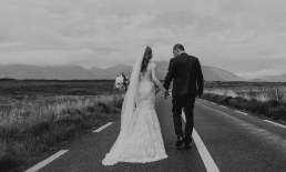 Bride and groom with view on Twelve Bens Mountain
