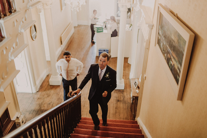 dad is seeing his daughter for the first time in her wedding dress