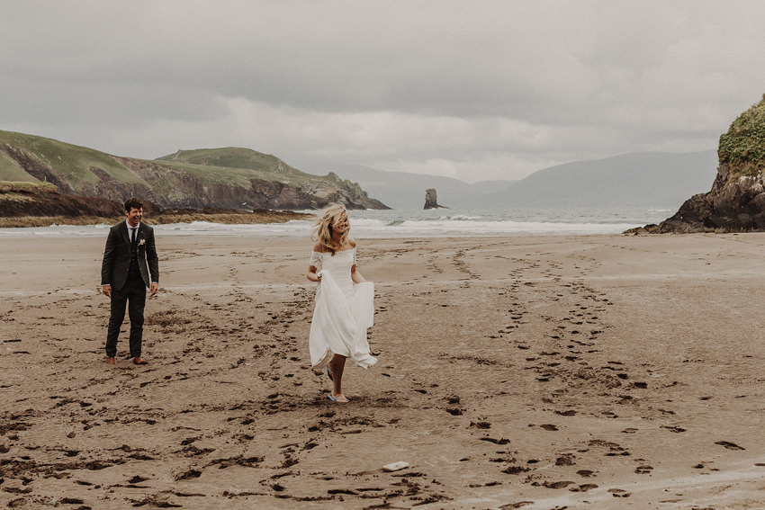 barefoot bride running on the beach