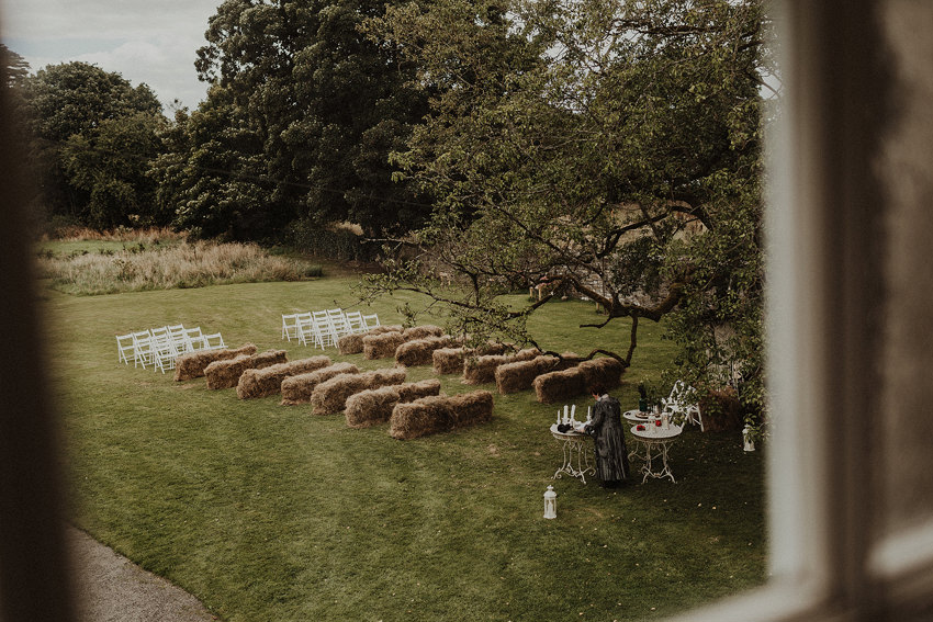 wedding ceremony under the three on the hay bales