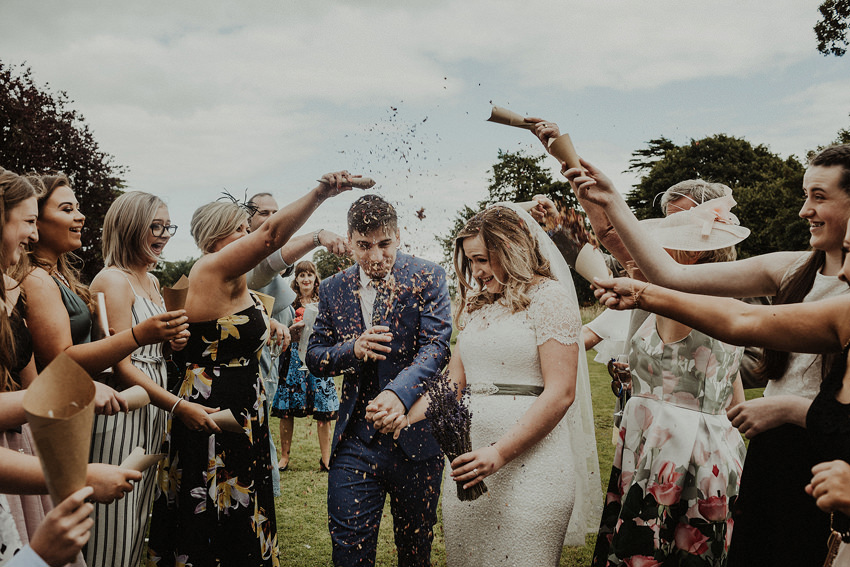 bride and groom doing confetti throw 