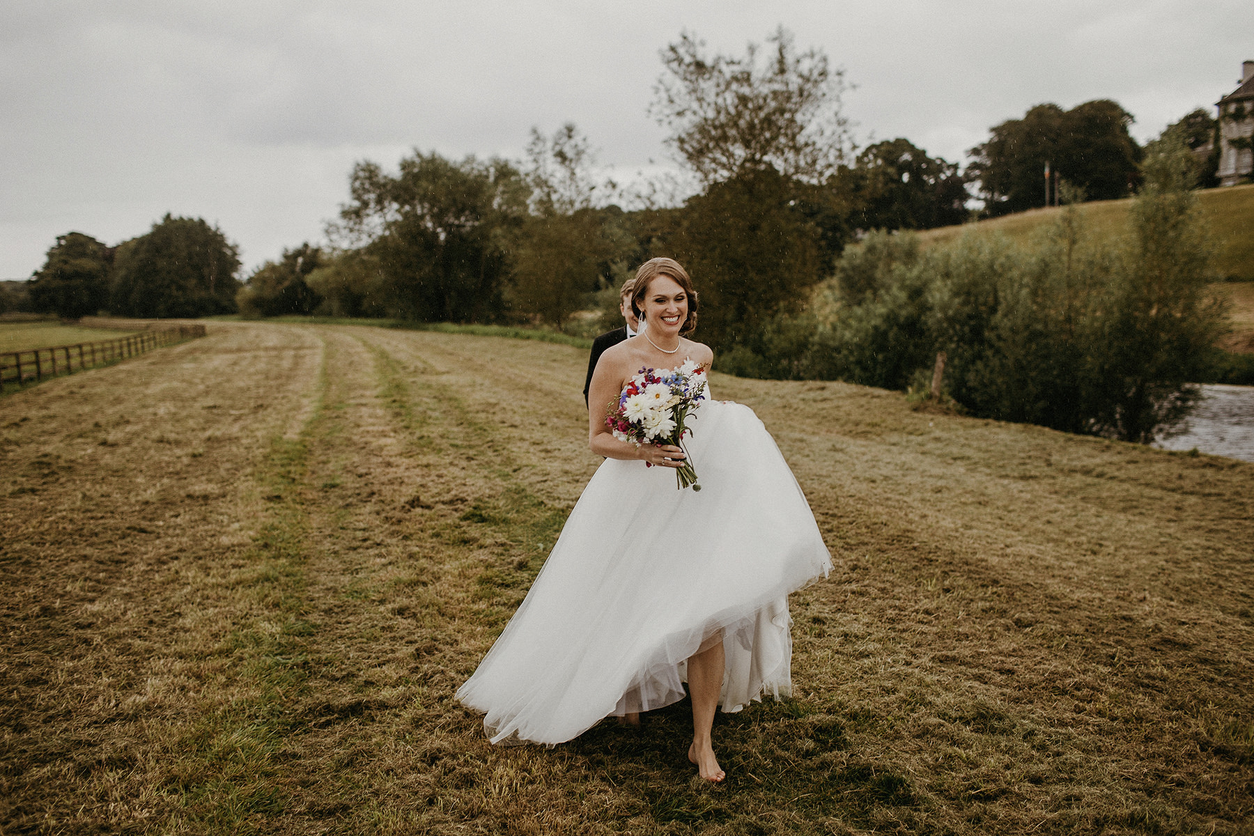 barefoot bride running laughing on the fields at mount juliet