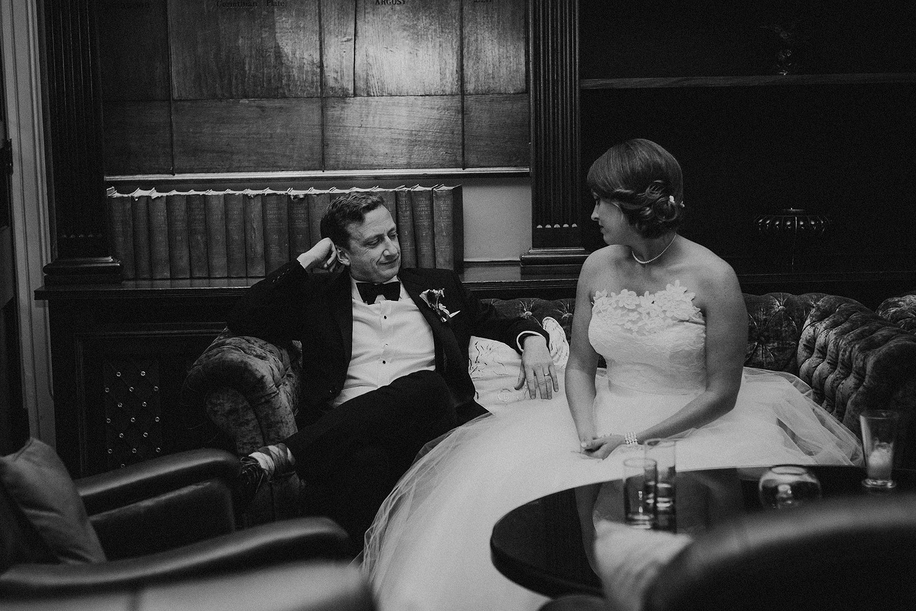 perfectly captured moment of bride and groom sitting on the sofa and having a relaxed chat before the first dance