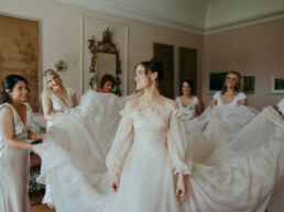Bride and Bridesmaids holding her dress